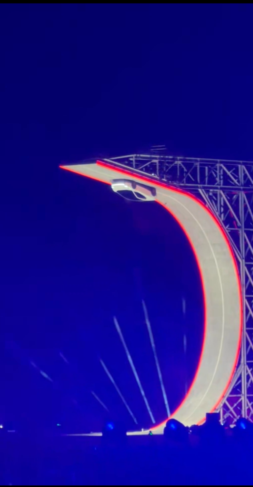 Tesla Roadster upside down at the top of the giant Hot Wheels-style loop ramp